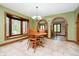 Cozy dining room with a wood table, chairs, and an arched entry to a second dining room at 5001 Woodrose Ln, Anderson, IN 46011
