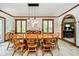 Elegant dining room with wood table, chairs, a modern light fixture, and wainscoting at 5001 Woodrose Ln, Anderson, IN 46011