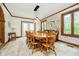 Spacious dining room featuring a wooden table, chairs, wainscoting, and access to the yard at 5001 Woodrose Ln, Anderson, IN 46011