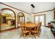 Dining room with wooden table, chairs, an arched doorway, and tiled flooring at 5001 Woodrose Ln, Anderson, IN 46011