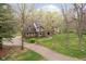 Charming brick home with Tudor accents, well-manicured lawn, and private wooded setting at 5001 Woodrose Ln, Anderson, IN 46011