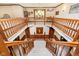 Grand two-story foyer with staircase, wood railings, chandelier, and a front door with sidelight windows at 5001 Woodrose Ln, Anderson, IN 46011