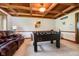 Recreation room featuring a foosball table, custom ceiling beams and wainscoting at 5001 Woodrose Ln, Anderson, IN 46011