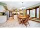 Cozy kitchen area featuring a wood table, chairs, a bay window, and tiled flooring at 5001 Woodrose Ln, Anderson, IN 46011