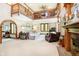 Bright living room with high ceilings, wooden details, comfortable seating, and a cozy fireplace at 5001 Woodrose Ln, Anderson, IN 46011