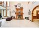 Elegant living room featuring a cozy fireplace, large windows, and open layout at 5001 Woodrose Ln, Anderson, IN 46011