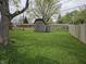 Large backyard featuring a wooden shed, ideal for storage, with a lush green lawn at 5107 Saddle Ln, Anderson, IN 46013