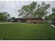 Charming single-story brick home featuring an attached garage and a well-maintained front yard at 5107 Saddle Ln, Anderson, IN 46013
