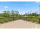 Spacious wooden deck overlooking a lush green lawn, mature trees, and a picturesque pond at 5141 S Cobblestone Dr, Zionsville, IN 46077