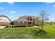 Beautiful brick two-story home with manicured lawn and landscaping on a sunny day at 5141 S Cobblestone Dr, Zionsville, IN 46077