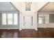 Bright foyer featuring hardwood floors, white pillars, and a view to rooms on either side at 5141 S Cobblestone Dr, Zionsville, IN 46077