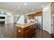 Open-concept kitchen with a granite-topped island, stainless steel appliances, and seamless flow into the living space at 5141 S Cobblestone Dr, Zionsville, IN 46077