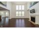 Bright living room with high ceilings, fireplace, hardwood floors, and large windows at 5141 S Cobblestone Dr, Zionsville, IN 46077