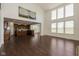 Bright, open-concept living room featuring hardwood floors and large windows adjacent to a kitchen with modern finishes at 5141 S Cobblestone Dr, Zionsville, IN 46077