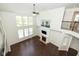 Spacious living room boasts a fireplace, hardwood floors, soaring ceilings, and clerestory windows for ample natural light at 5141 S Cobblestone Dr, Zionsville, IN 46077