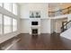 Large living room with high ceilings, hardwood floors, fireplace, and open layout to upper level at 5141 S Cobblestone Dr, Zionsville, IN 46077