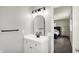 Bright bathroom featuring a modern vanity, a decorative mirror, and glass enclosed shower at 5354 Brendon Park Dr, Indianapolis, IN 46226