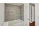 Updated bathroom features tiled wall surround in shower and new fixtures at 5354 Brendon Park Dr, Indianapolis, IN 46226