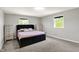 A bright bedroom features neutral paint, plush carpet, and double windows for natural light at 5354 Brendon Park Dr, Indianapolis, IN 46226