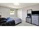 This bedroom features neutral walls, carpet, and a modern dresser with mounted mirror and TV at 5354 Brendon Park Dr, Indianapolis, IN 46226