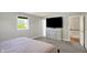 Bedroom showcases carpet, neutral walls, a modern dresser with mounted TV, and window with natural light at 5354 Brendon Park Dr, Indianapolis, IN 46226