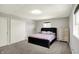 Bedroom featuring neutral walls, carpet, a black bed frame, two windows, and matching dressers at 5354 Brendon Park Dr, Indianapolis, IN 46226