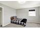 Cozy bedroom features a black and white plaid bedspread and neutral walls and carpet at 5354 Brendon Park Dr, Indianapolis, IN 46226