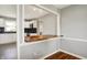 A kitchen view highlighting the live edge breakfast bar, white cabinetry, and stainless steel appliances at 5354 Brendon Park Dr, Indianapolis, IN 46226