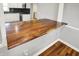 A breakfast bar features a live edge countertop adding natural beauty to the kitchen space at 5354 Brendon Park Dr, Indianapolis, IN 46226