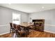 A dining room showcases hardwood floors, neutral walls, and a rustic dining set for Gathering meals at 5354 Brendon Park Dr, Indianapolis, IN 46226