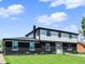 Charming two-story home featuring a striking black brick facade, well-manicured lawn, and a bright white front door at 5354 Brendon Park Dr, Indianapolis, IN 46226