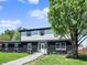Charming two-story home boasts a striking black brick facade and a welcoming front yard with mature trees at 5354 Brendon Park Dr, Indianapolis, IN 46226