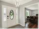 Bright foyer with statement light fixture, leading to dining room and featuring vinyl flooring at 5354 Brendon Park Dr, Indianapolis, IN 46226