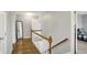 An upstairs hallway features hardwood flooring, with access to bedrooms and bathrooms at 5354 Brendon Park Dr, Indianapolis, IN 46226