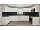 Modern kitchen with white cabinetry, stainless appliances, and stylish backsplash at 5354 Brendon Park Dr, Indianapolis, IN 46226