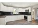 Well-lit kitchen with stainless appliances, white cabinets, and black backsplash at 5354 Brendon Park Dr, Indianapolis, IN 46226