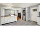 The kitchen features gray flooring, stainless appliances, and an island with a live edge countertop at 5354 Brendon Park Dr, Indianapolis, IN 46226