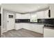 Modern kitchen featuring white cabinets, black backsplash, and new stainless appliances at 5354 Brendon Park Dr, Indianapolis, IN 46226