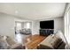 Open-concept living room featuring hardwood floors, comfortable seating, and abundant natural light at 5354 Brendon Park Dr, Indianapolis, IN 46226