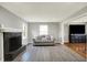 Bright living room with fireplace, grey flooring, and modern decor at 5354 Brendon Park Dr, Indianapolis, IN 46226
