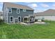 Spacious backyard with manicured lawn, fence, patio, grill, and outdoor furniture, ideal for relaxation and entertaining at 5363 Citadel Dr, Noblesville, IN 46062