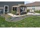 This backyard offers a private patio with furniture, an outdoor grill, and professionally landscaped elements at 5363 Citadel Dr, Noblesville, IN 46062