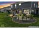 An inviting backyard patio features a pergola with cozy seating and a built-in grill, perfect for outdoor entertaining at 5363 Citadel Dr, Noblesville, IN 46062
