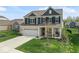 Charming two-story home with a well-manicured lawn, two car garage, and inviting front porch at 5363 Citadel Dr, Noblesville, IN 46062