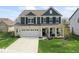 Charming two-story home with a well-manicured lawn, two car garage, and inviting front porch at 5363 Citadel Dr, Noblesville, IN 46062