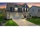 Beautiful two-story home with a well-manicured lawn, two car garage, and inviting front porch at 5363 Citadel Dr, Noblesville, IN 46062