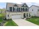 Beautiful two-story home with a well-manicured lawn, two car garage, and inviting front porch at 5363 Citadel Dr, Noblesville, IN 46062