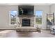 Hardwood floors and a stone fireplace with a large TV in the living room at 5363 Citadel Dr, Noblesville, IN 46062