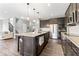 Open kitchen boasts a large island, stainless appliances, granite counters, and hardwood floors at 5363 Citadel Dr, Noblesville, IN 46062