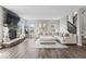Bright living room with fireplace, large sectional sofa, and hardwood floors at 5363 Citadel Dr, Noblesville, IN 46062